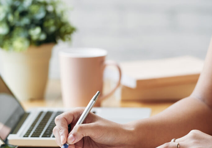 Hands of business lady writing schedule for the upcoming week